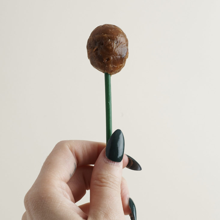 a Super Bombon Supercoco Coconut Lollipop in a hand