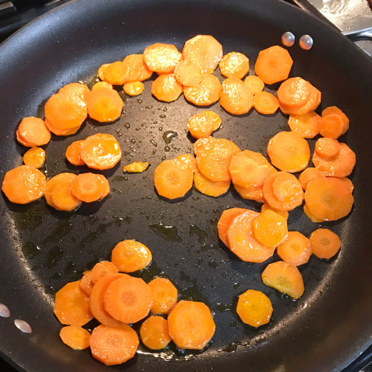 sliced carrots cooking in pan