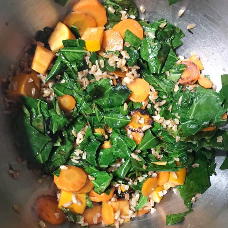 completed collard green, persimmon, carrot and goat cheese salad