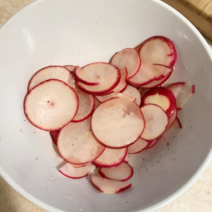 sliced radishes marinating in bowl