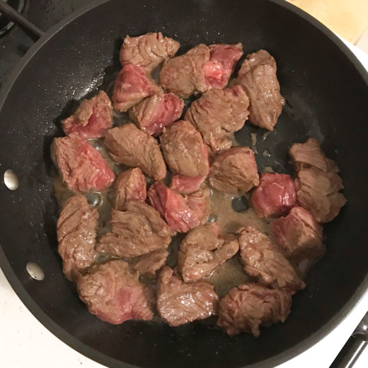 cubed beef cooking in pan