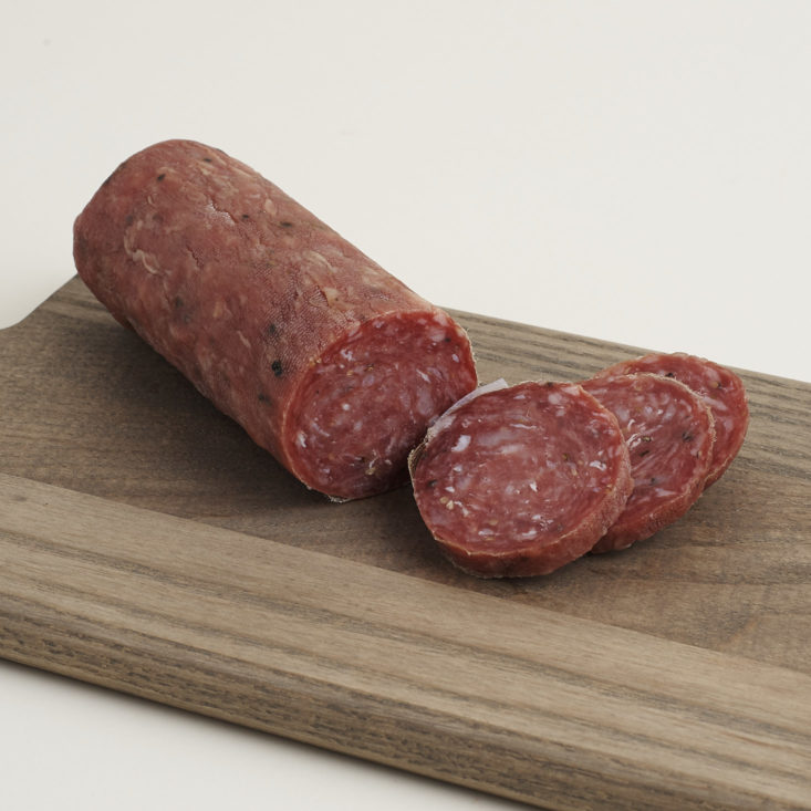 Mild Soppresata from Parma Sausage sliced on a cutting board