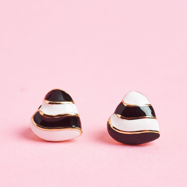 black and white heart earrings from earfleek on their sides