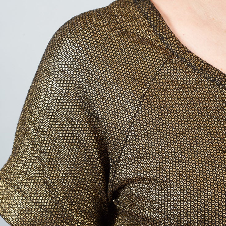 close up of gold pattern on shiny dress