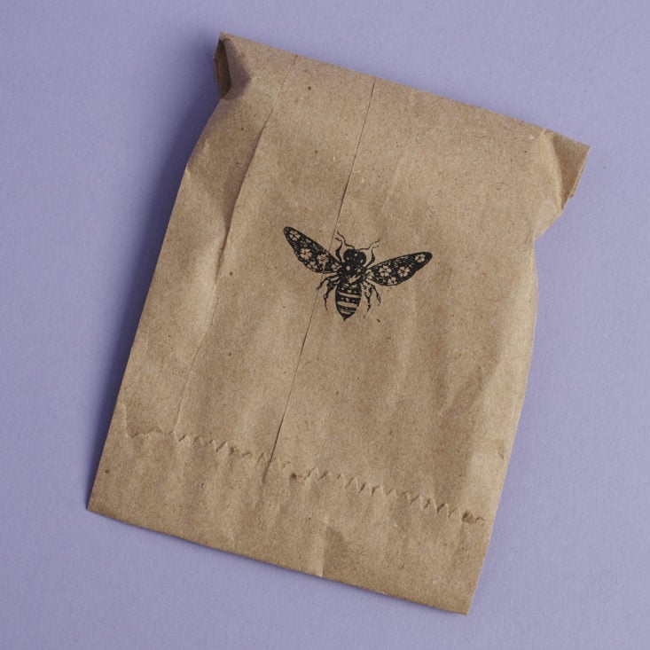 kraft paper bag with heart and honey bee logo stamped on it