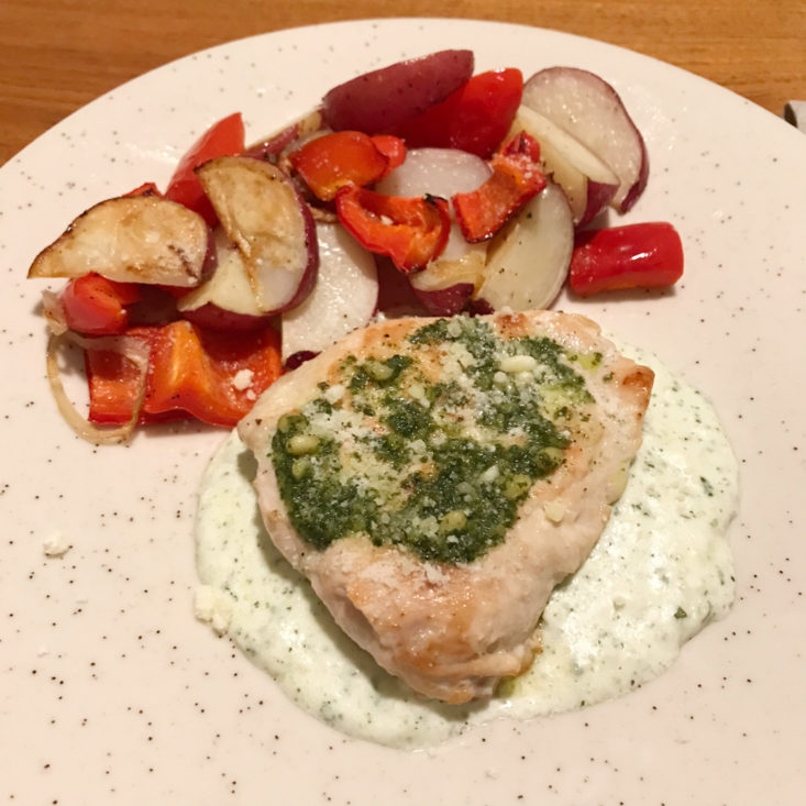 close up of finished chicken with basil-pecorino cream sauce with roasted red potatoes and red peppers