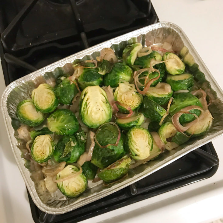 cooked halved brussels sprouts with sliced shallots in tin