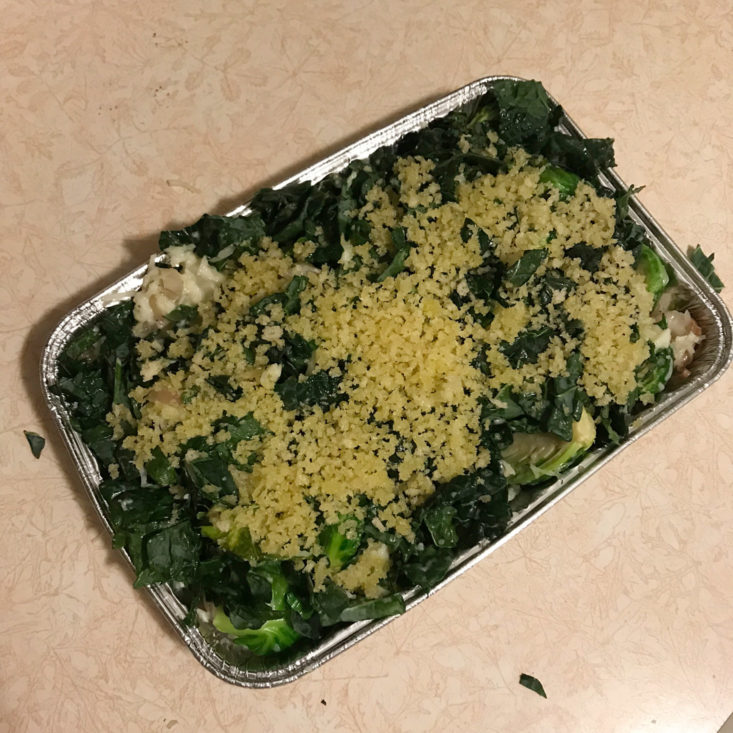 cooked brussels sprouts with sliced shallots in tin, mixed with cream, fontina, and kale, topped with breadcrumbs