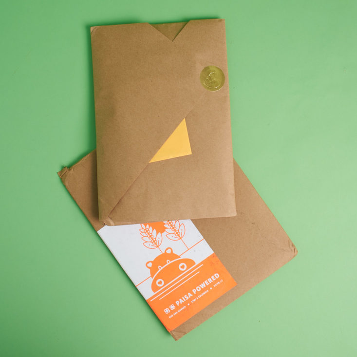 kraft paper-wrapped packet out of envelope