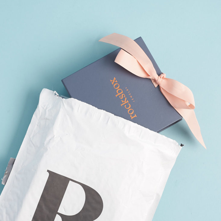 rocksbox coming out of shipping envelope
