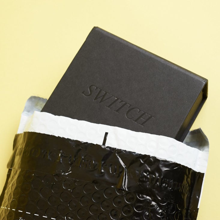 switch box coming out of black envelope