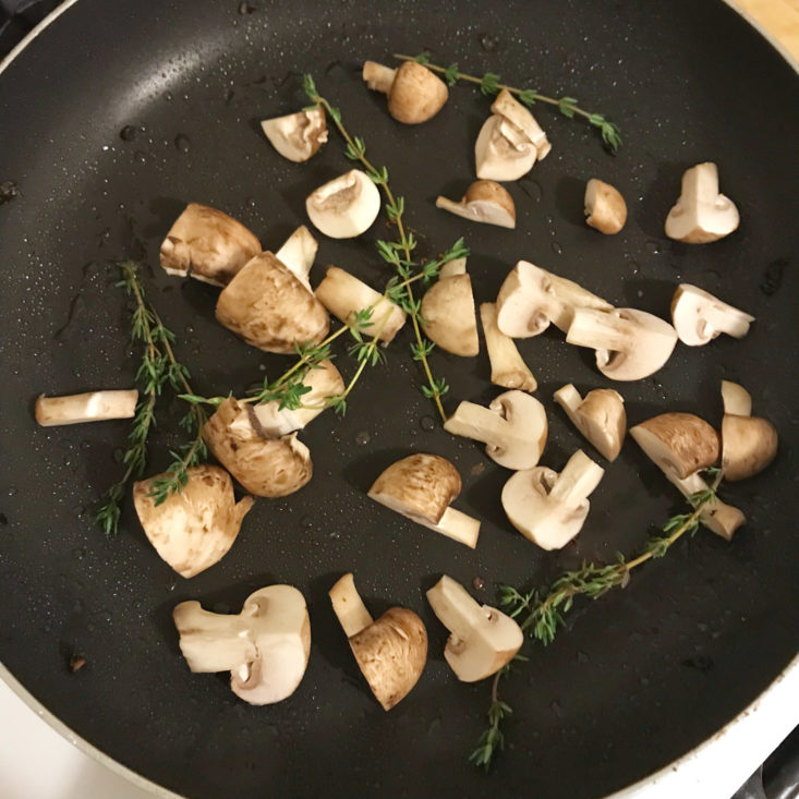mushrooms and thyme cooking in pan