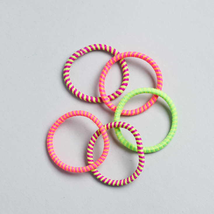 five neon hair ties laying on top of one another