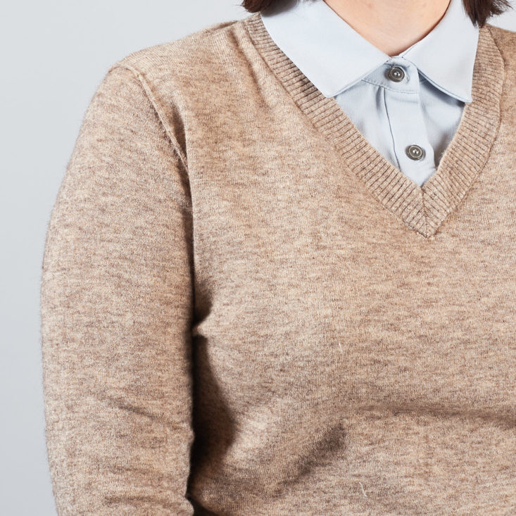 closeup of tan sweater over blue collar