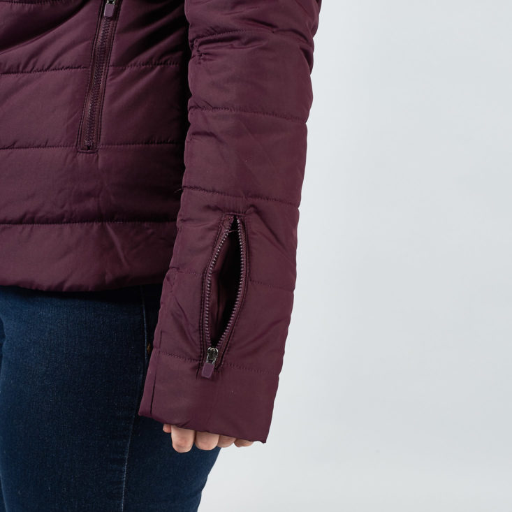 This purple puffer jacket from Fabletics has a zippered pocket on the sleeve.