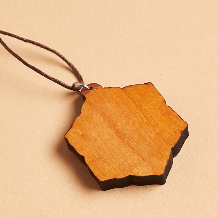 back of wooden pendant on long cord