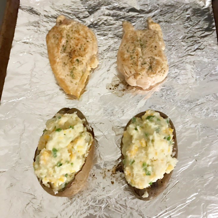 jalapeno popper twice baked potatoes and chicken breasts on cookie sheet