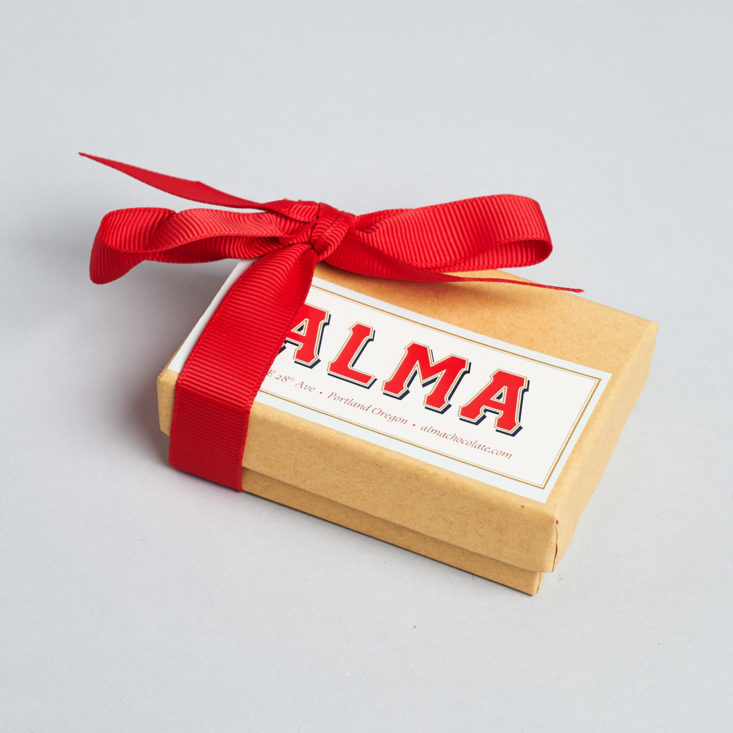 small box of alma chocolates tied with a red bow
