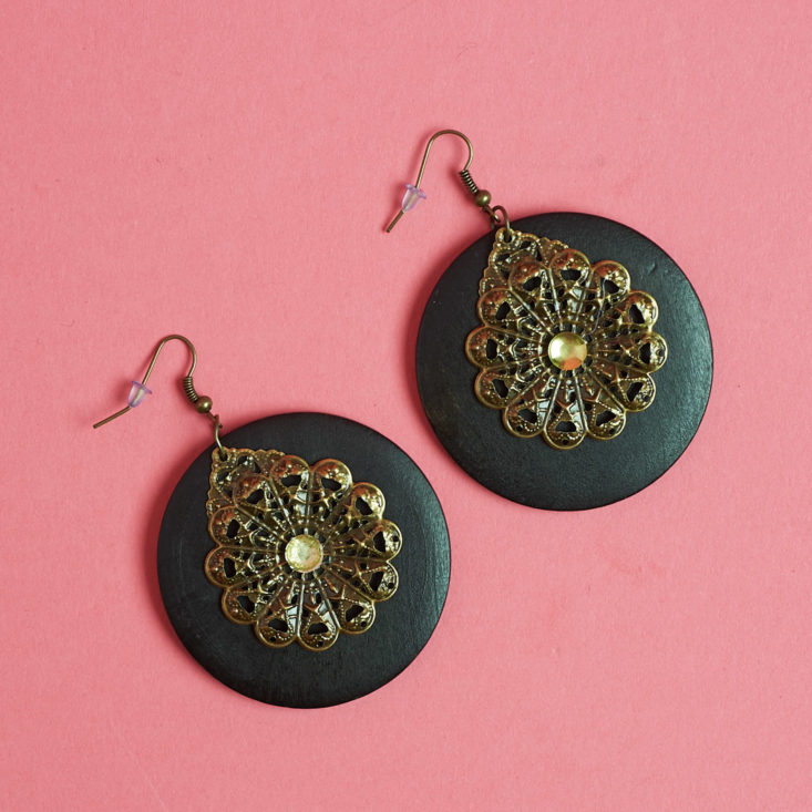 These disc shaped earrings have brass accents on them