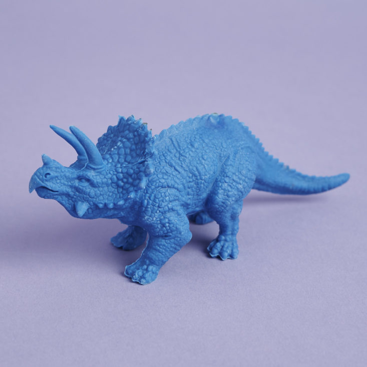 an oversized bright blue triceratops eraser