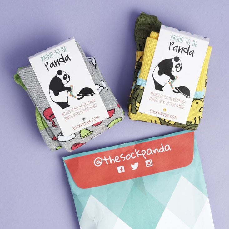 two pairs of socks popping out of sock panda envelope
