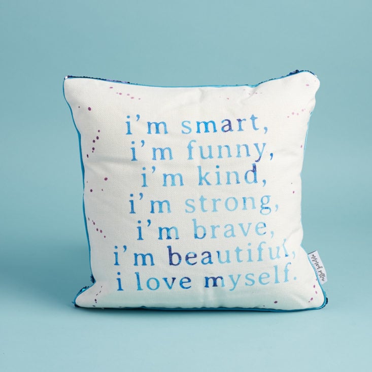 white pillow with mermaid back and an inspiring quote written in teal on the front