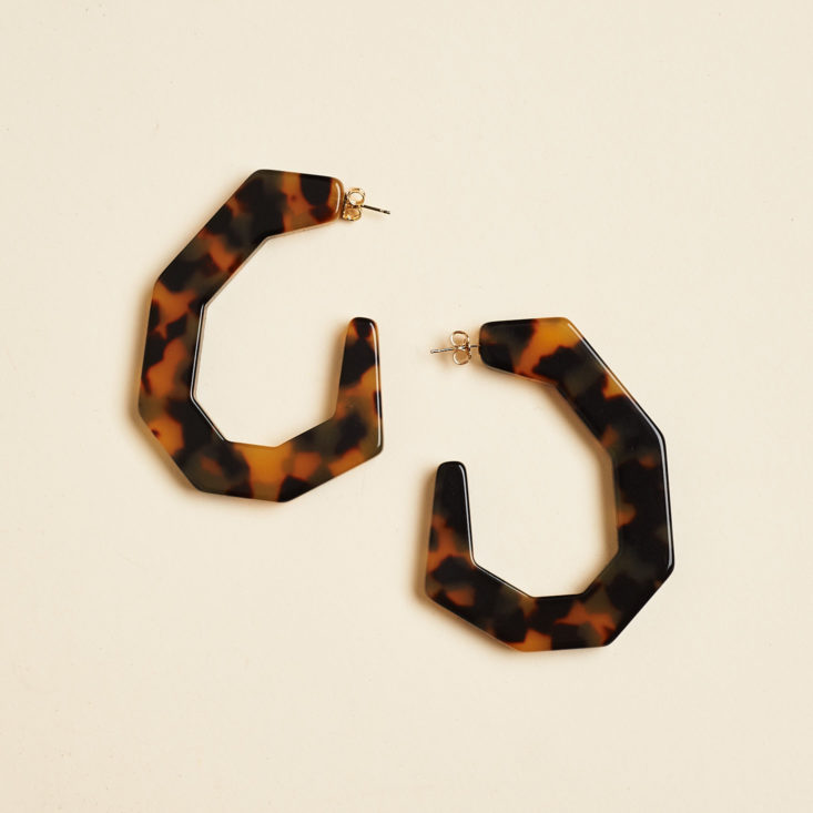 c-shaped large earrings on their side