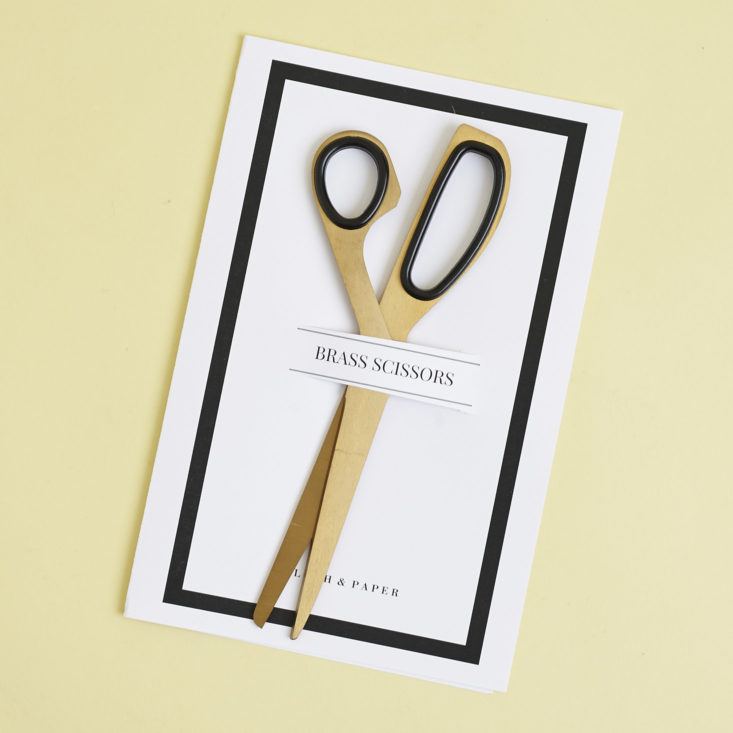 brass scissors on packaging card