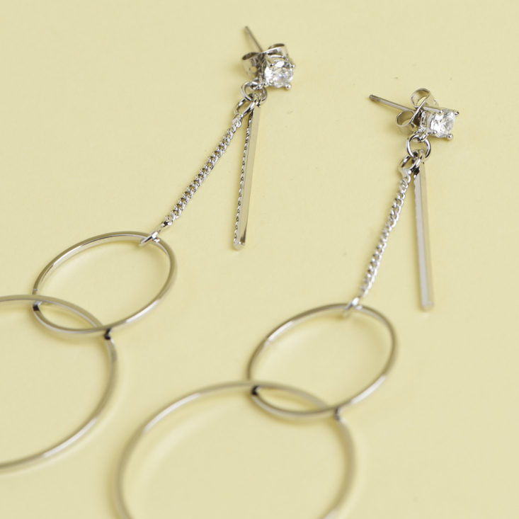 close up of silver mod modesty earrings