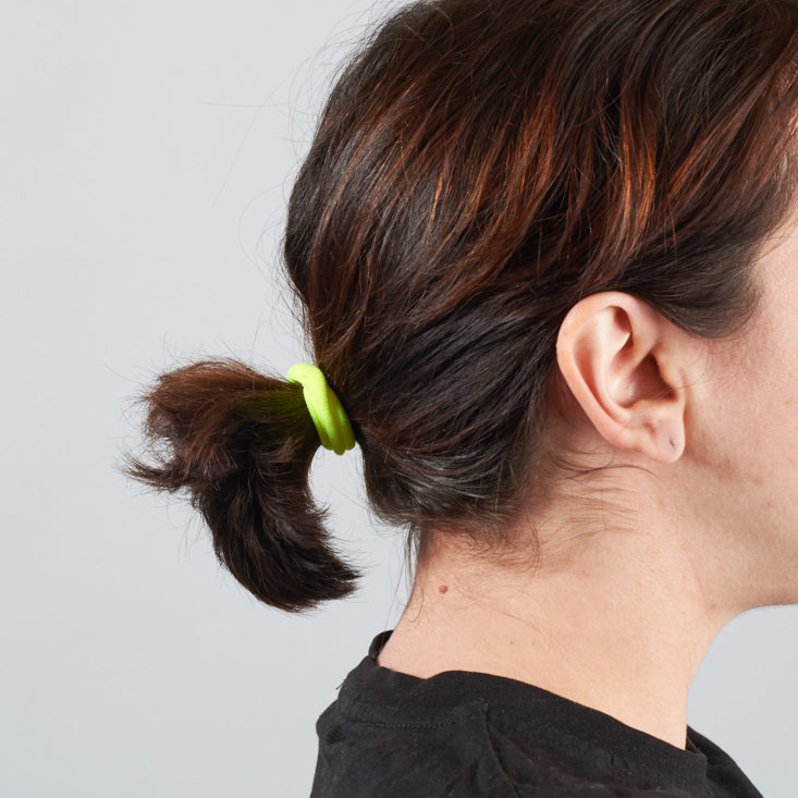 neon yellow hair tie in ponytail