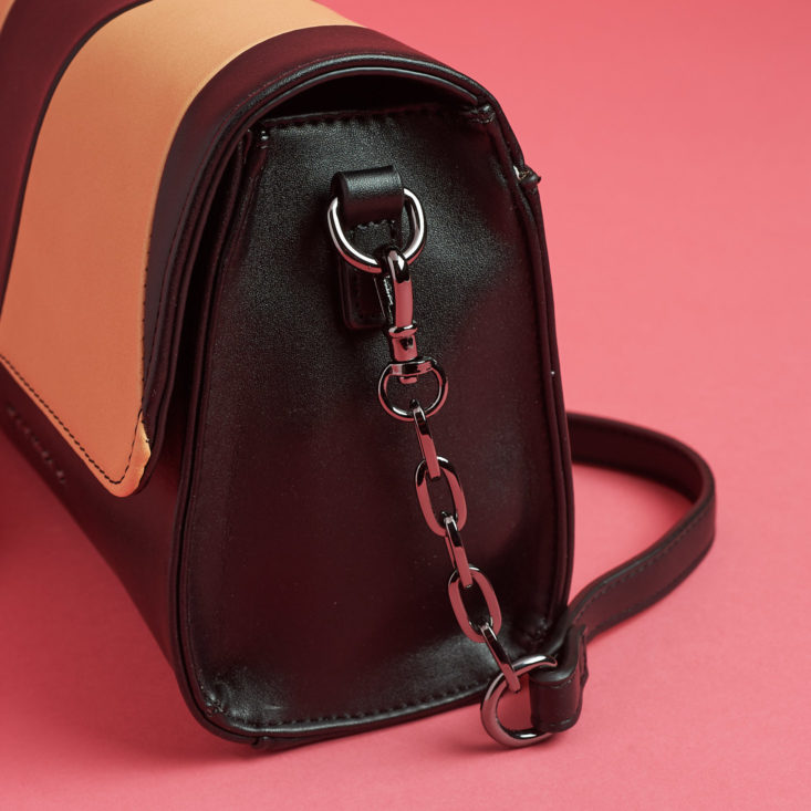 chain detail on tan and black bag