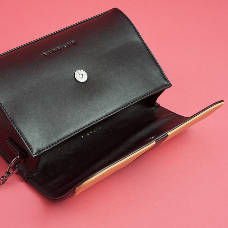 magnetic clasp on black and tan handbag