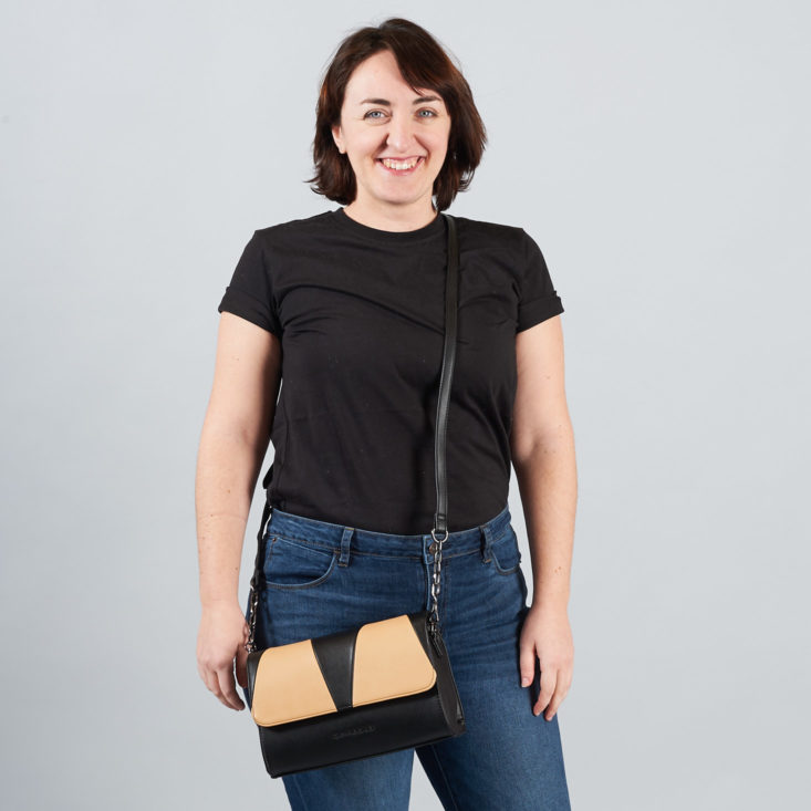 woman wearing tan and black handbag