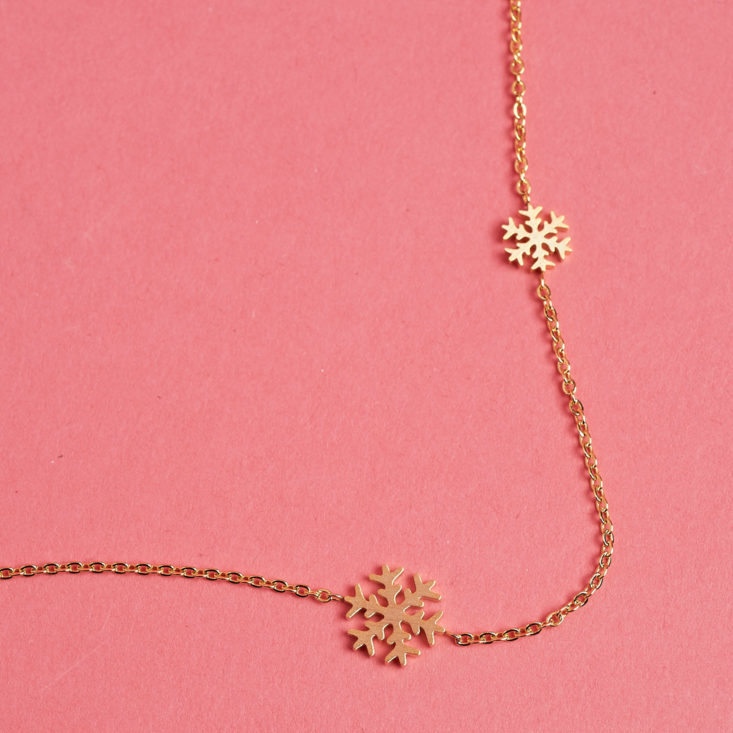 closeup on snowflake necklace with two flakes
