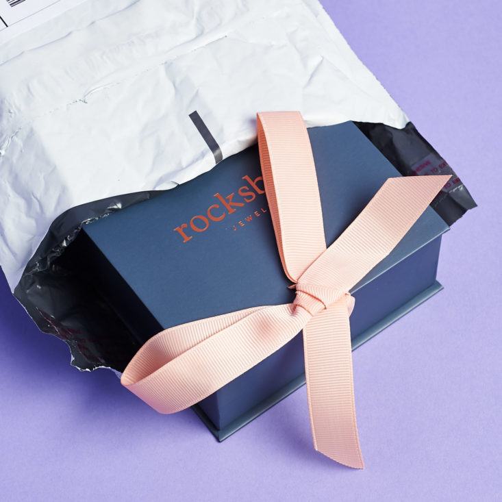 rocksbox blue box inside shipping envelope