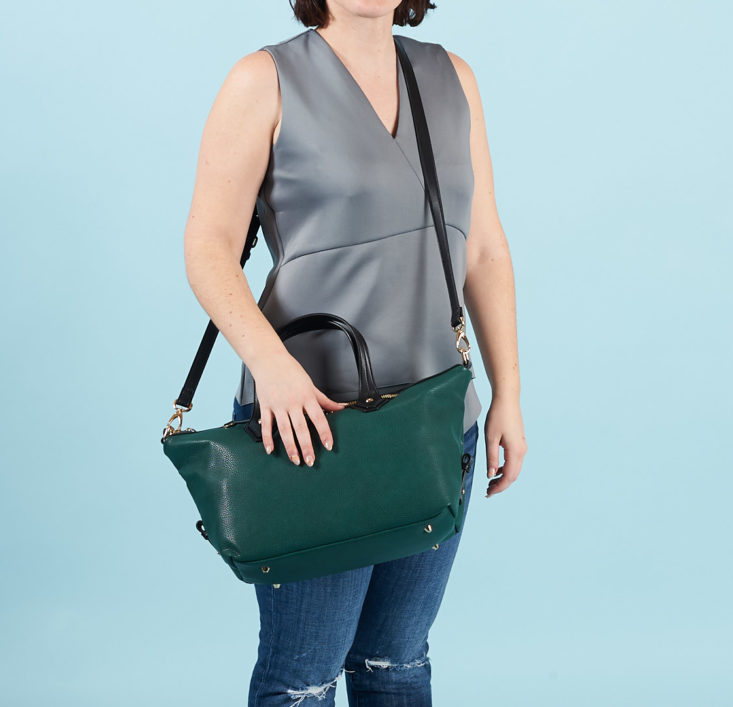 teal satchel purse with shoulder strap on model