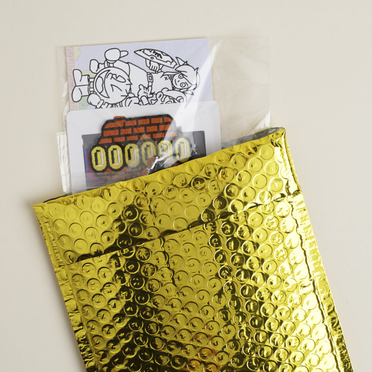 Laserbrain Patch Co bubble mailer with items peeking out