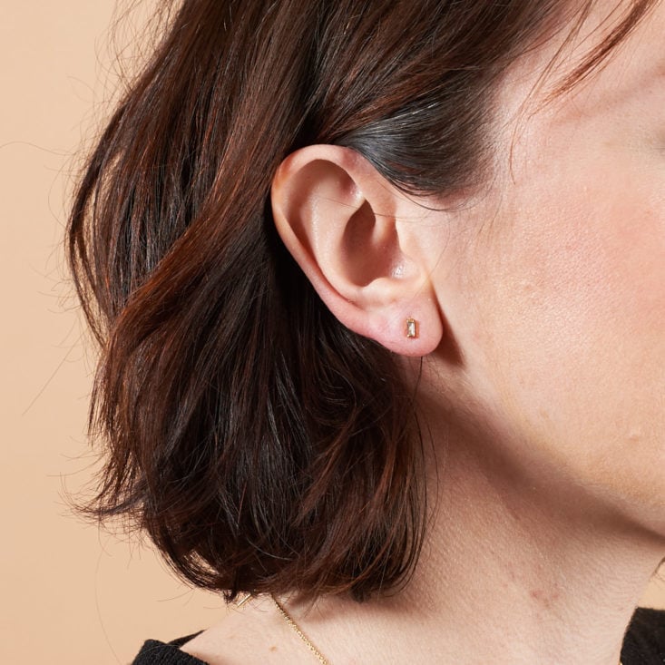 tiny crystal earrings on model