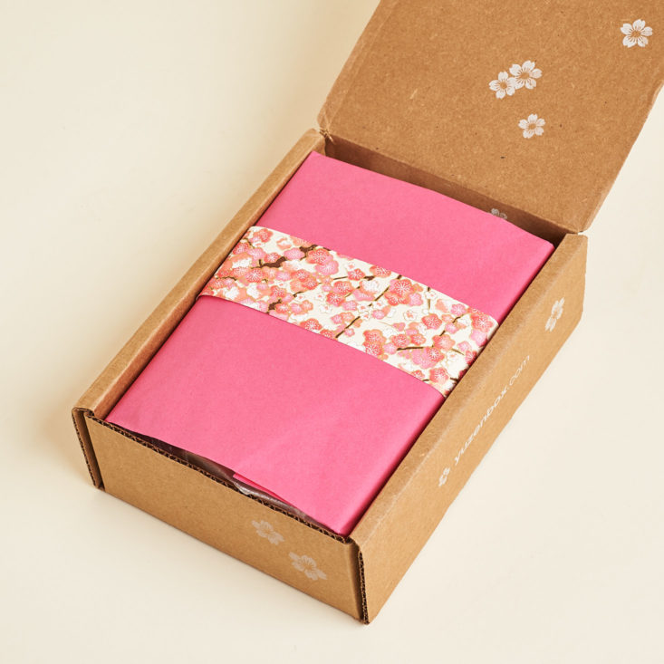 open Yuzen Box with pink tissue paper and cherry blossom band
