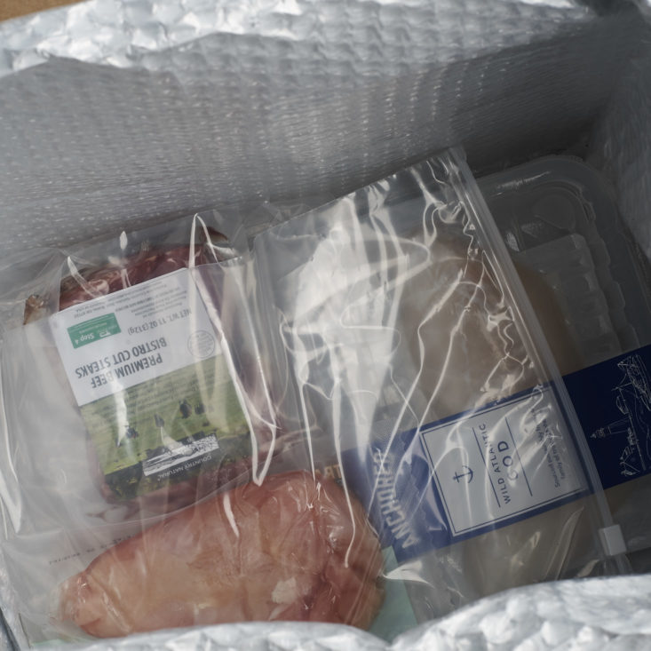 ice pack + meat under cardboard divider