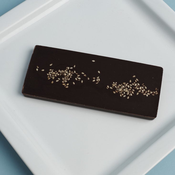 back of Elements Truffles Ginger and Black pepper Artisanal Chocolate Bar on plate