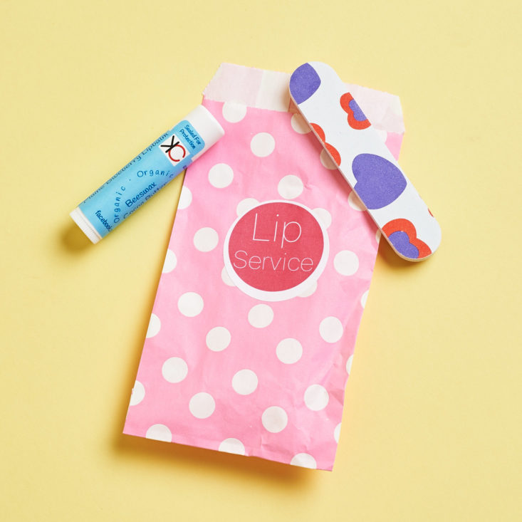 pink polka dot pouch with nail file and lip balm