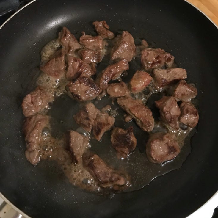 beef cooking in pan