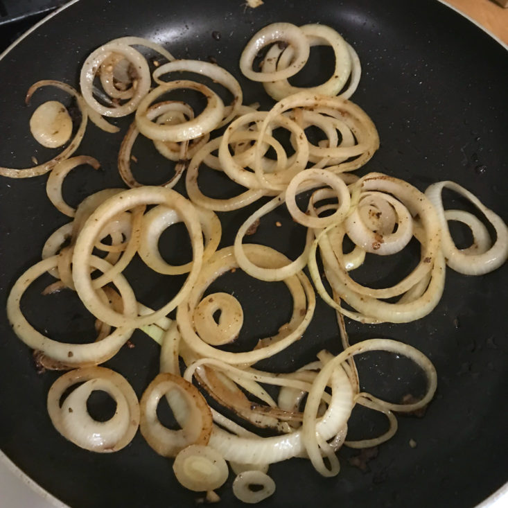 onions cooking in pan with ginger