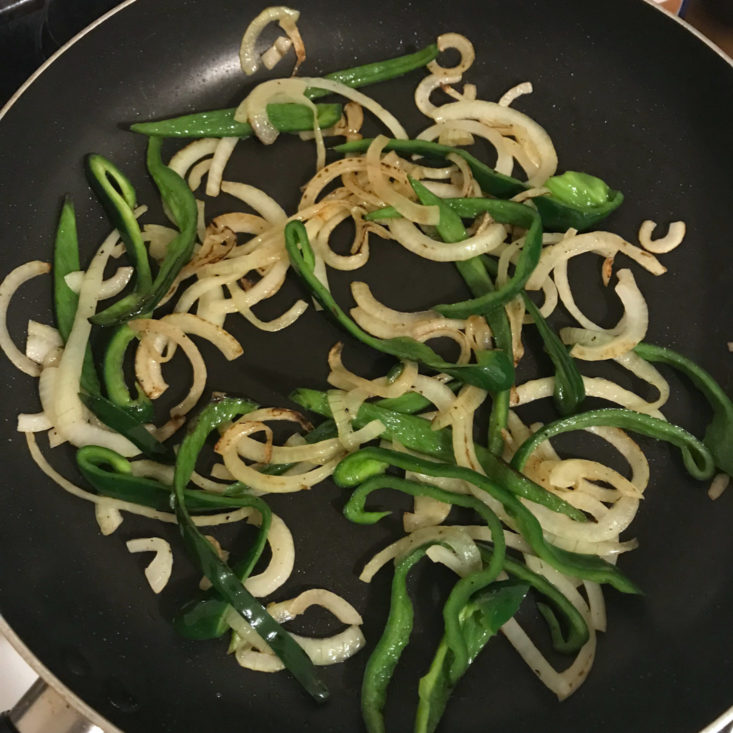 poblano peppers and onions cooking in pan