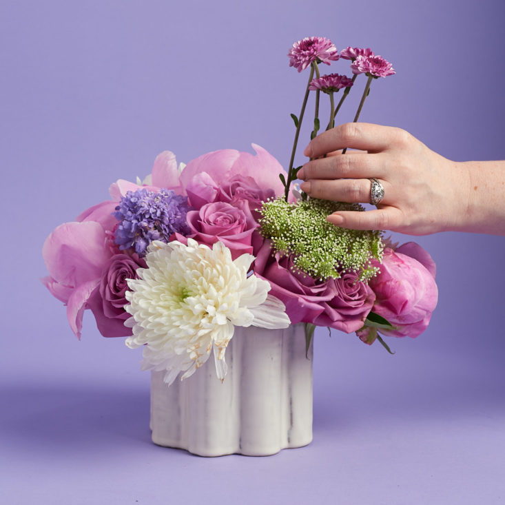 Adding Button Mums to the vase