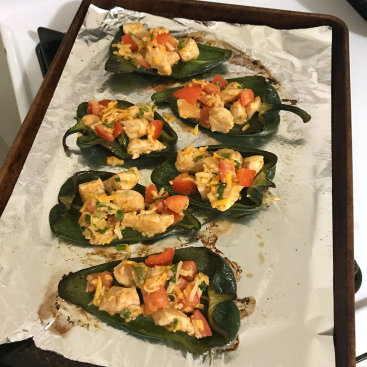 chicken filling in peppers on baking sheet