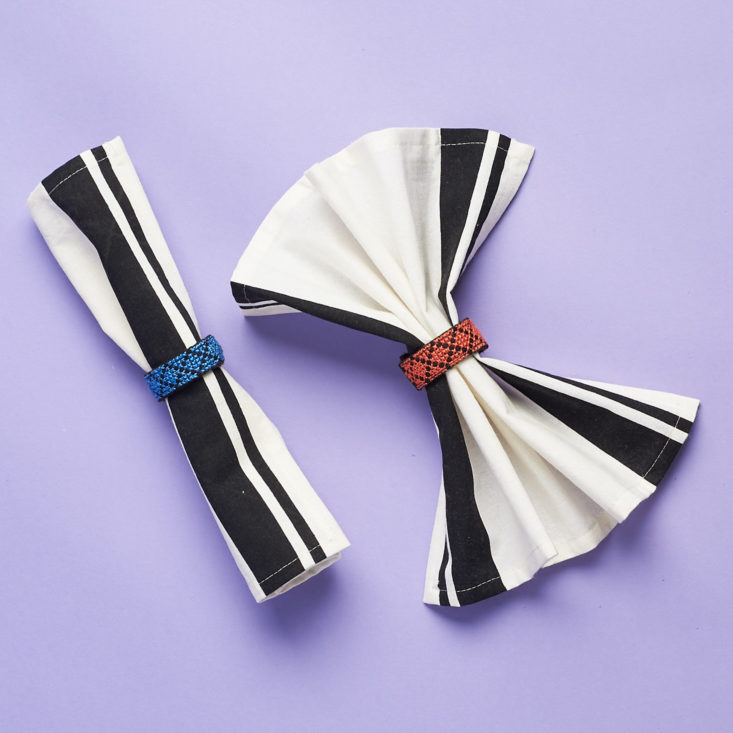 globein black striped napkins with rings on them