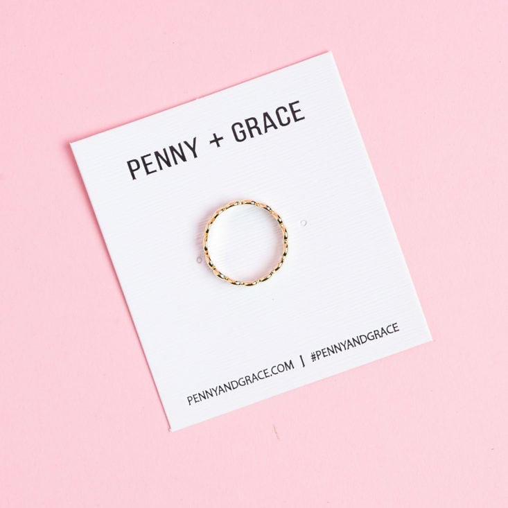 penny and grace gold ring on backing