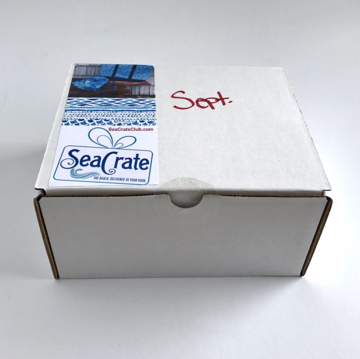 closed white cardboard box with SeaCrate printed on top